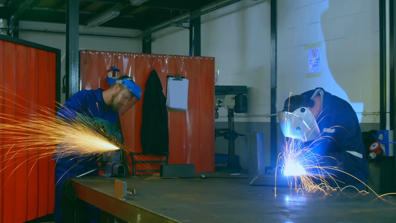 Time lapse of workers using grinder and welding torch in workshop 4k