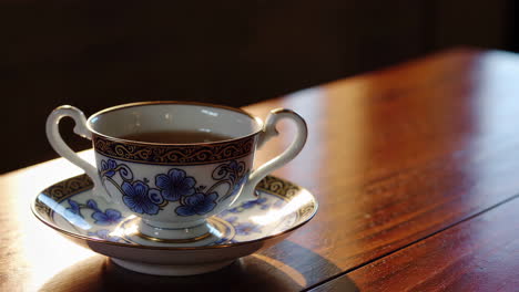 steaming cup of tea on wooden table