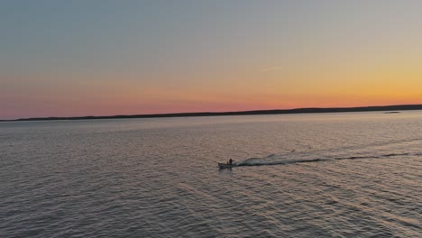 Ein-Boot,-Das-Bei-Sonnenuntergang-über-Das-Wasser-Fährt