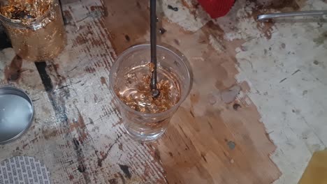 Mixing-epoxy-resin-with-golden-leaves