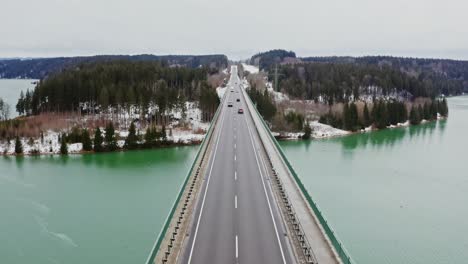 winter road bridge over turquoise lake