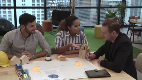 Creative-business-people-group-having-conversation-at-office-desk-in-workplace.