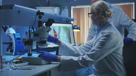 scientists in a laboratory analyzing samples under microscope