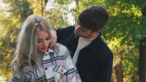 romantic man kisses girlfriend on the cheek