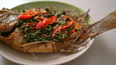 Fried-Tilapia-Fish-with-Basil-chili-garlic-sauce-on-top---homemade-food-style