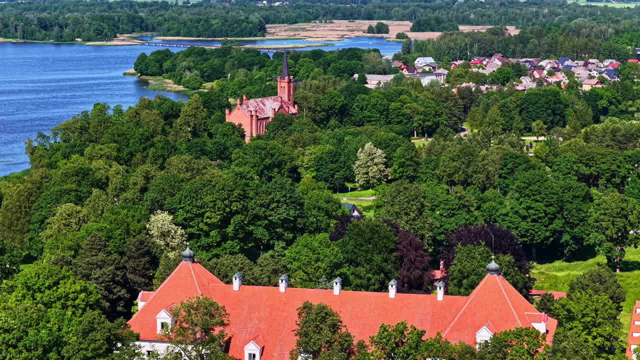 Birzai castle and church in background by Sirvena lake. Aerial view