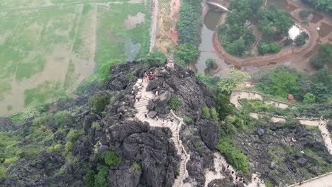 aerial from the top of vietnamese dragon temple on top of large limestone karst