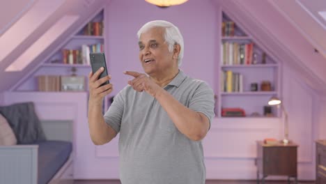 Happy-Indian-old-man-talking-on-video-call