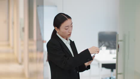 businesswoman holding documents and color swatches in an office