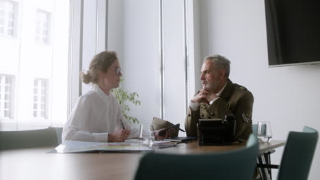 young woman talking with military man