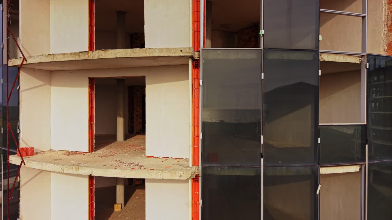 Construction progress at a high-rise building site during the day