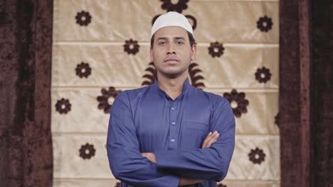 confident muslim man standing crossed hands