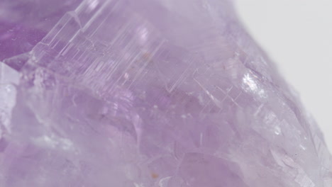 macro shot of light purple quartz like rock spinning around showing rough texture on surface