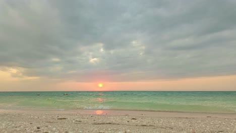 sunset time-lapse over turquoise sea at punta cocos beach, holbox, mexico