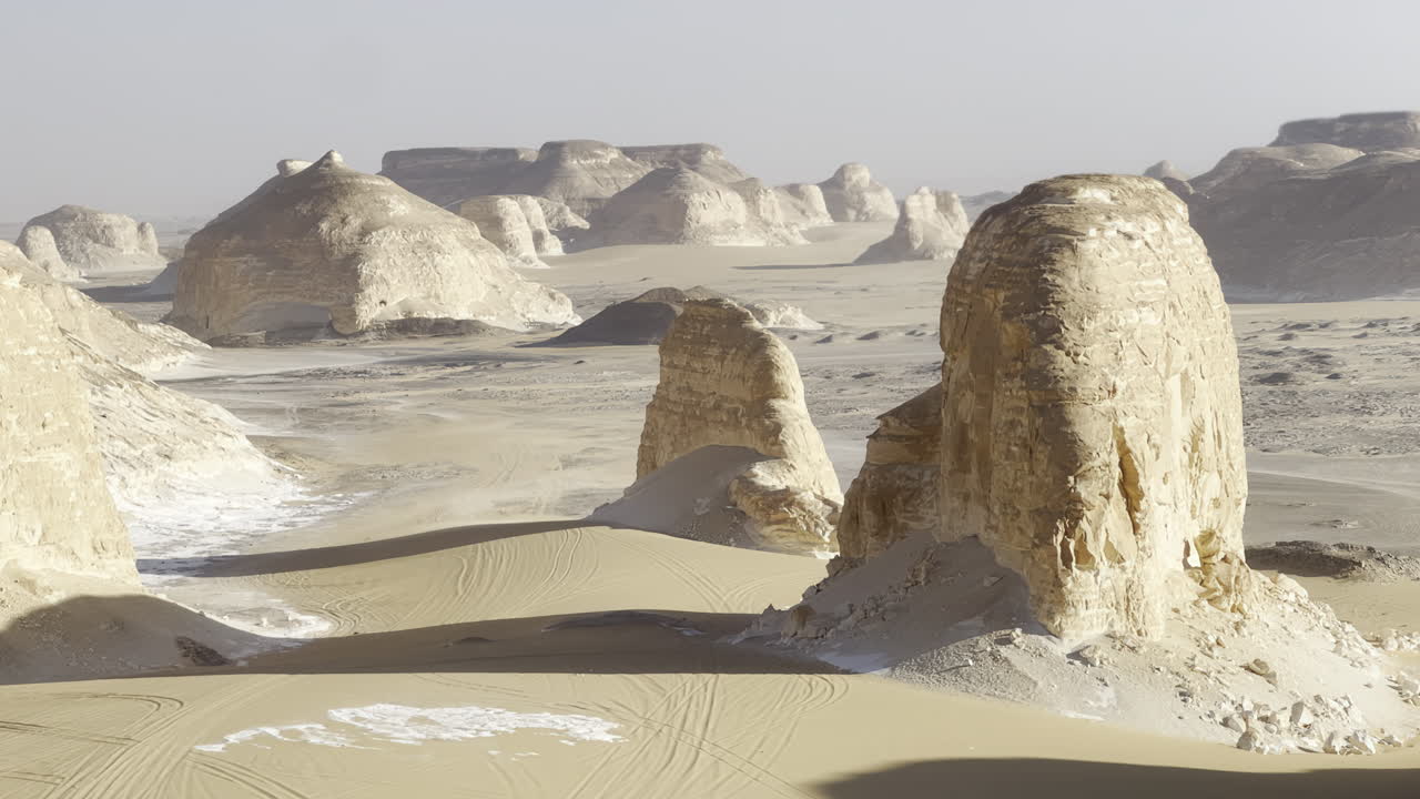 The Egyptian white desert adventure tourism with bedouin camping and 4x4 driving through the desert to see rock formation and sand and dust at sunset and golden hour
