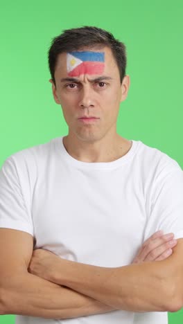 dignified and serious man with philippine flag painted on face