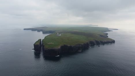 Drone-shoot-looking-back-from-the-sea-after-dawn-at-the-peninsula-and-lighthouse