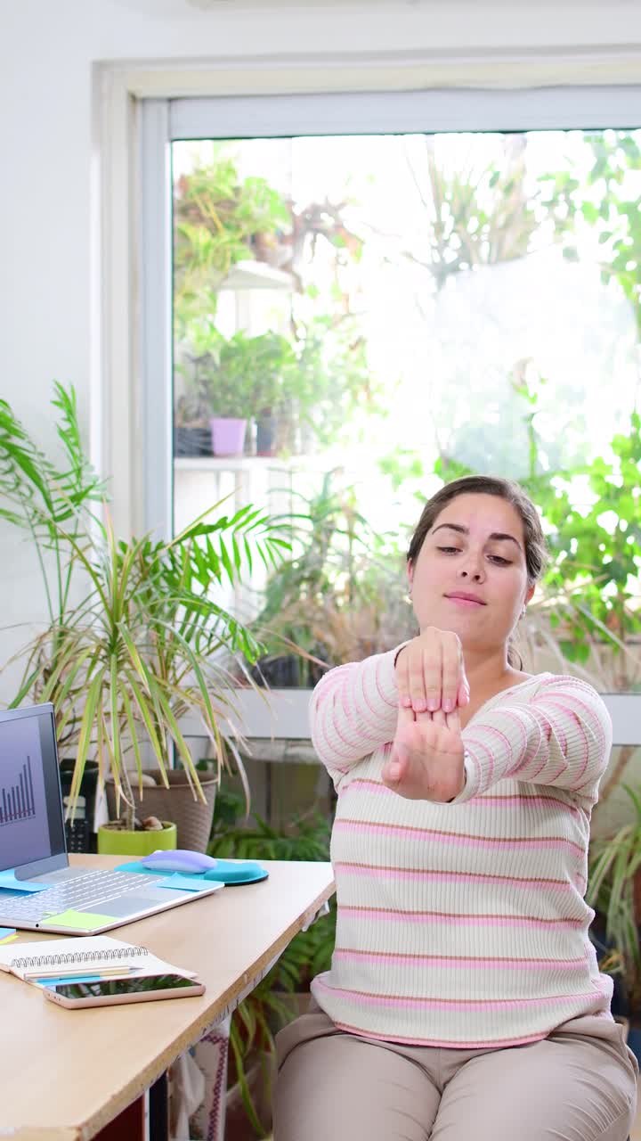 Businesswoman stretching his arms.