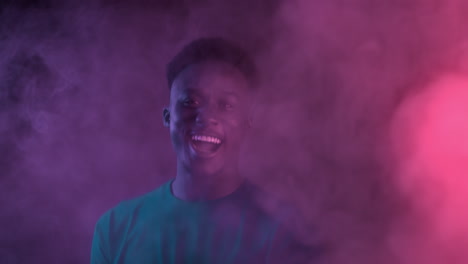 happy man in neon smoke