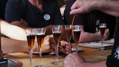 sommelier prepares glasses of wine during a tasting tour