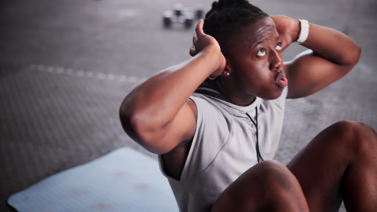 Man doing sit-ups in a gym