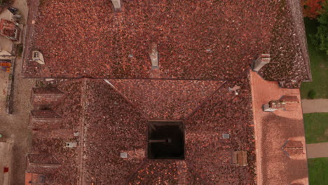 Top-down-aerial-lift-of-small-courtyard-on-monumental-building-in-rural-Switzerland