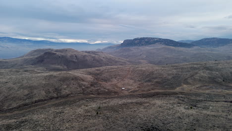 drone glance over kamloops' rugged hills at dusk