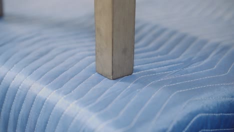 a close up of a wobbly furniture dining chair leg on a carpentry work bench