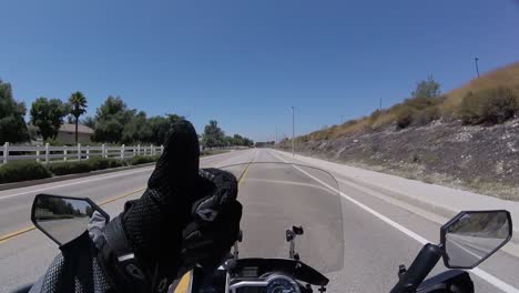 rider driving fast motorbike on highway showing thumb up pov