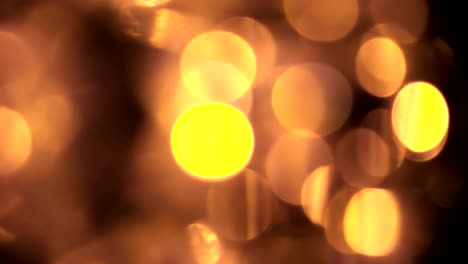 abstracto circular dorado brillo brillo bokeh movimiento fluido en fondo negro, felicitación fiesta de saludo feliz año nuevo, celebración de navidad