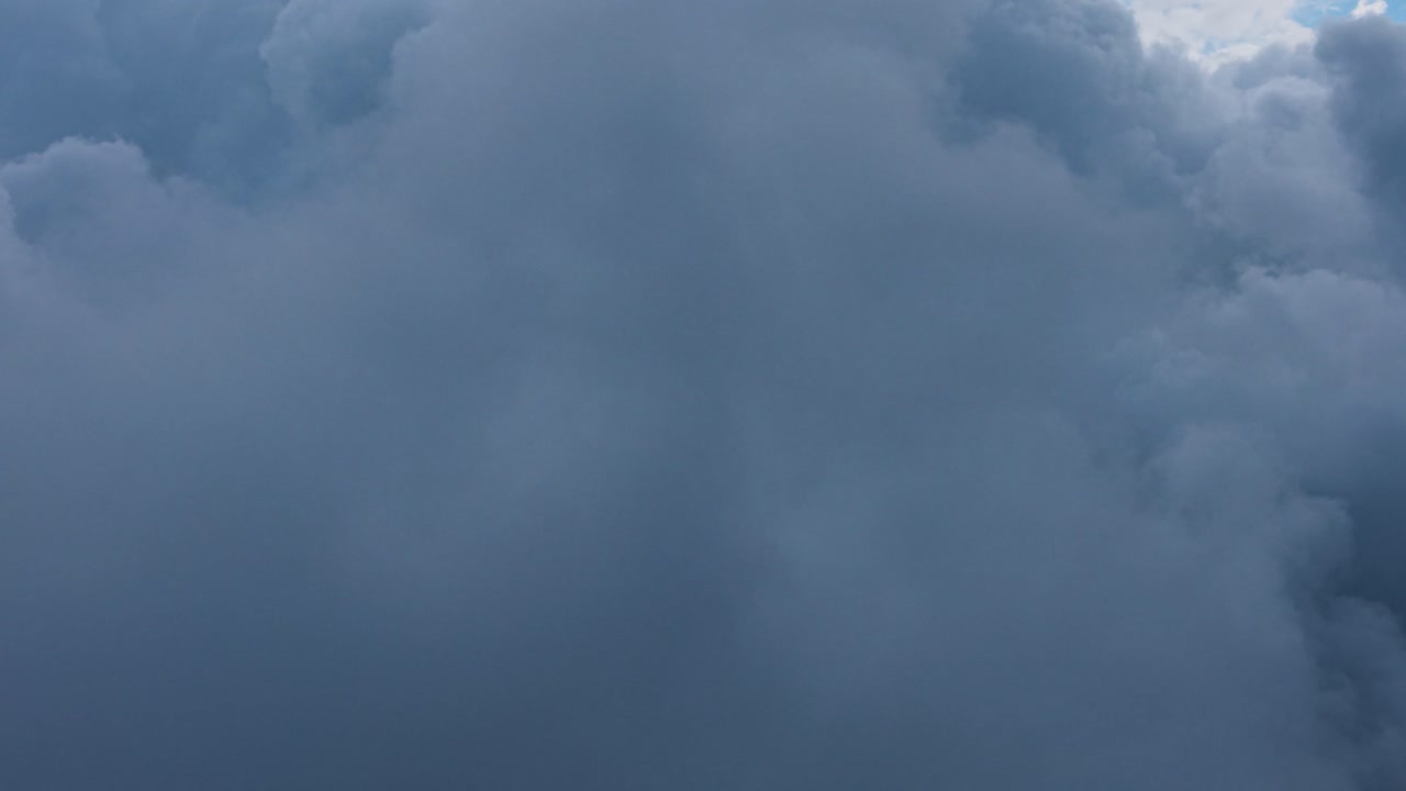 Aerial footage from drone soaring through clouds to great heights
