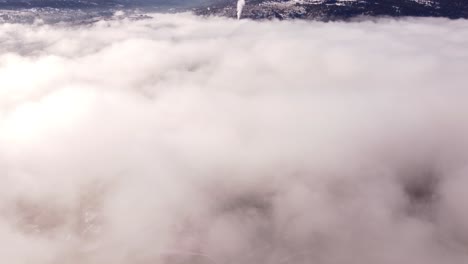 aerial-view-of-dense-cityscape-through-clouds