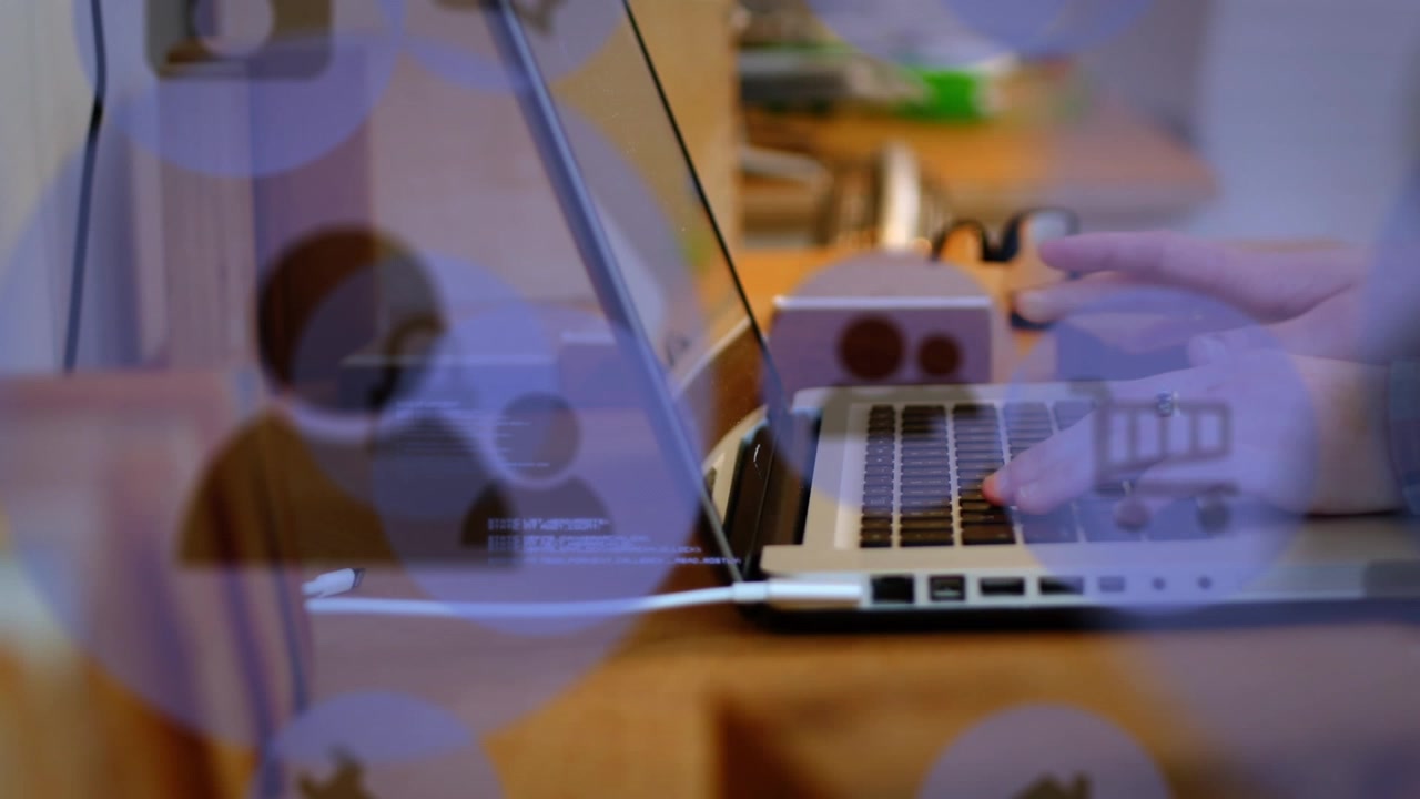 Animation of technology icons over caucasian woman using laptop