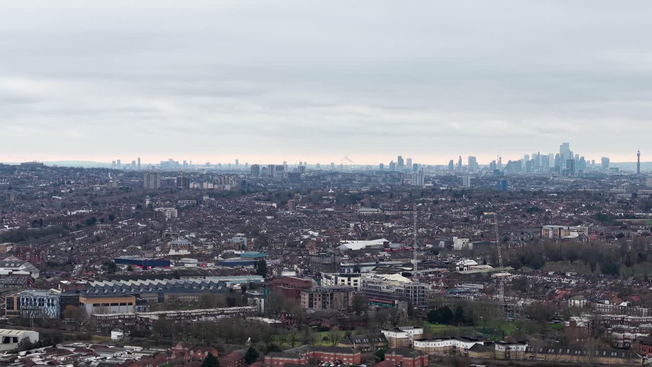 Distant View Of City Skyline From Wembley Suburb In London Borough of Brent, UK. aerial sideways shot