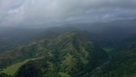 Downhill-horizon-view-with-green-mountains-cloudy-sky