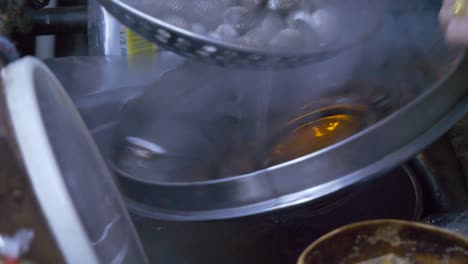 cooking blood clams in boiling water at thailand night market food booth street