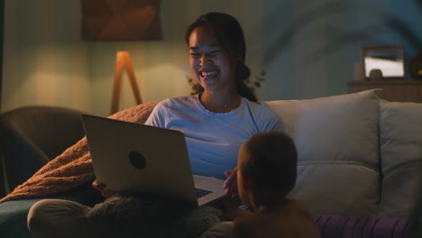 mother and child enjoying family time with a laptop