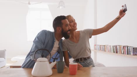 happy couple taking a selfie indoors