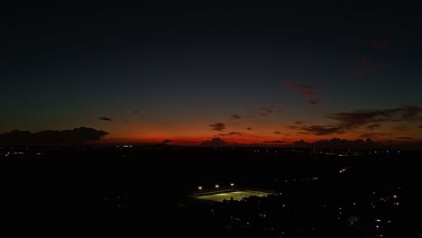 time-lapse of a sunset over mauritius, with cars and city lights illuminating roads beneath the colorful fading sky.