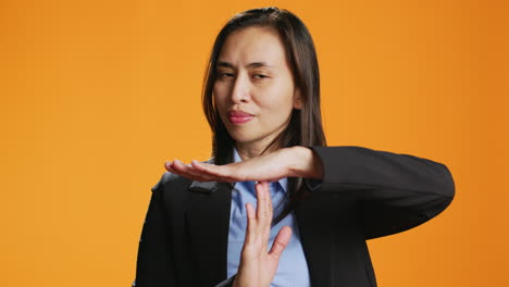 young woman showing timeout symbol in studio