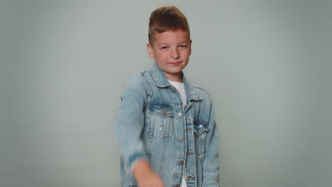 toddler boy pointing to camera and looking with playful happy expression, making choice, hey you