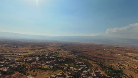 panoramic aerial wide view across sprawling agricultural town and farmland in desert