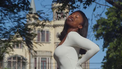 enjoying a day in the city, a young girl in a white bodysuit enjoys the view of castles