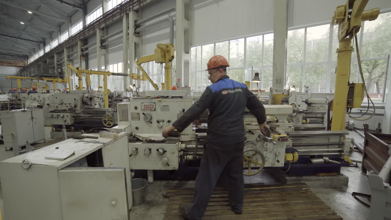 Industrial Workers Operating Metal Lathes in a Factory