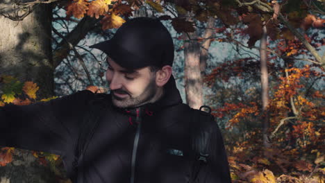 caucasian male taking off face mask outside, forest in background, end of covid pandemic, head closeup