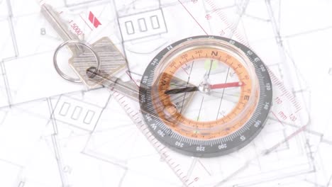 Animation-of-compass-and-house-keys-over-house-plans