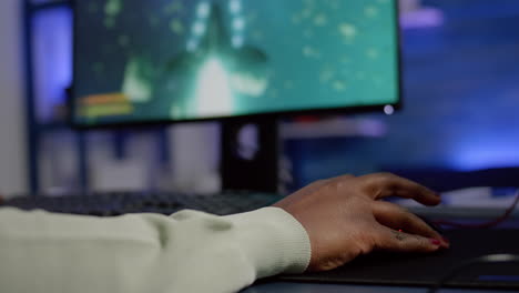 Close-up-of-african-woman-cyber-moving-professional-mouse-with-RGB