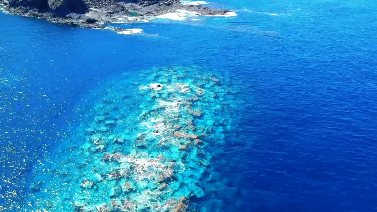 Aerial drone footage of the natural pools of Garachico Caletón. Blue ocean and the natural pools functioning as playas at Tenerife. Nice waves hit the rocks in the water