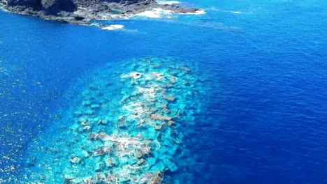 aerial drone footage of the natural pools of garachico caletón. blue ocean and the natural pools functioning as playas at tenerife. nice waves hit the rocks in the water