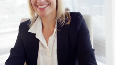 businesswoman working over laptop at her desk